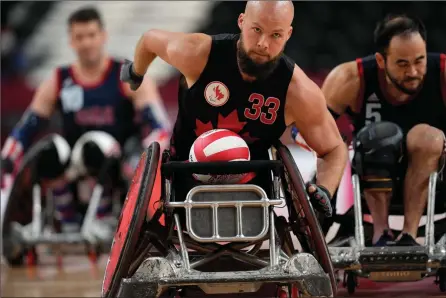 ?? The Associated Press ?? Canada’s Zak Madell moves the ball during wheelchair rugby at the Tokyo Paralympic Games, Thursday, in Tokyo, Japan.