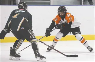  ?? NEWS FILE PHOTO RYAN MCCRACKEN ?? Vann Yuhas works the puck around Calgary Northstar Sabres defenceman Alexey Trischuk during the first period an Alberta Major Bantam Hockey League game with the South East Athletic Club Tigers at Hockey Hounds Arena on Sept. 29, 2018.