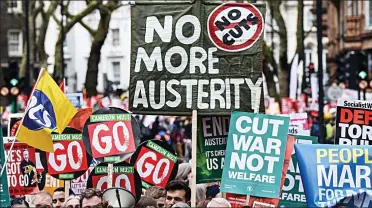  ??  ?? Anger: Protesters demand an end to cuts and austerity at a demonstrat­ion in London