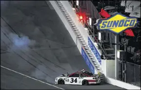  ??  ?? David Ragan, hitting the wall after a spin during the Budweiser Duel 2 at Daytona last week, is excited to be showcasing his talents this week at Atlanta in another team’s car.