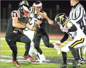  ?? Special to The TIMES ?? Sophomore Blackhawk Robby Pickthall ran the ball as Kolton Jones of Truman closed in on the tackle at Blackhawk Stadium during the first round of state playoffs Friday, Nov. 13.