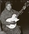  ?? AP PHOTO ?? Sister Rosetta Tharpe, guitarplay­ing American gospel singer, gives an impromptu performanc­e in 1957 in a lounge at London Airport, following her arrival from New York.