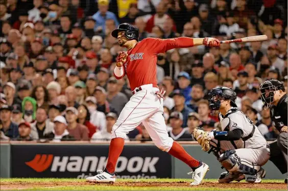  ?? Winslow Townson / Getty Images ?? Boston’s Xander Bogaerts watches his two-run home run against Gerrit Cole of the Yankees during the first inning of the AL wild-card game at Fenway Park on Tuesday night. The Red Sox will face the Tampa Bay Rays starting on Thursday in Florida for the best-of-five Division Series.