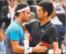  ?? Eric Feferberg / AFP / Getty Images ?? Novak Djokovic, right, congratula­tes Marco Cecchinato after Tuesday’s quarterfin­al match in the French Open in Paris.