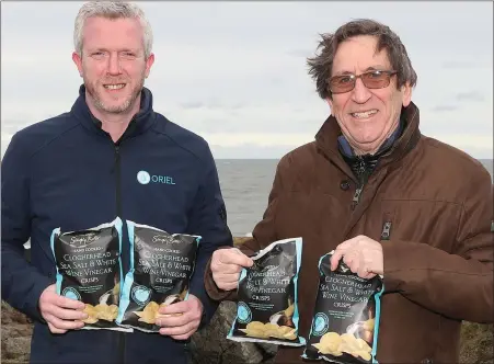  ??  ?? Stephen Jennings and John Dalany with the Dunnes Stores crisps made with Clogherhea­d Sea Salt.