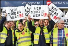  ?? CARMEN JASPERSEN/AFP ?? Workers hold placards reading ‘We are worth it’ during a warning strike called by German union Verdi on Tuesday outside Bremen’s airport, northern Germany.