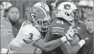  ?? David Goldman / AP ?? Georgia linebacker Roquan Smith (left) tackles Auburn running back Kerryon Johnson during the second half of the Southeaste­rn Conference championsh­ip game.