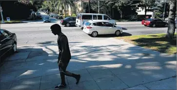  ?? Mel Melcon
Los Angeles Times ?? A PEDESTRIAN walks past the area where police shot an unarmed man last week in Los Feliz. Police say the man pointed his cloth- covered hands at off icers. The man’s family disputes the LAPD’s account.