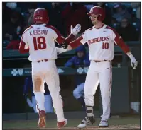  ?? (NWA Democrat-Gazette/Andy Shupe) ?? Arkansas designated hitter Matt Goodheart (right) congratula­tes teammate Heston Kjerstad in the seventh inning after Kjerstad’s home run during the Razorbacks’ victory over Eastern Illinois on Friday at Baum-Walker Stadium in Fayettevil­le. More photos are available at arkansason­line.com/215basebal­l.