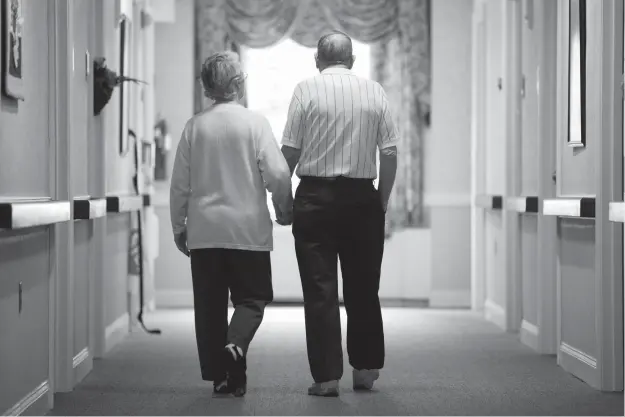  ?? Associated Press ?? An elderly couple walks down a hall Nov. 6, 2015, in Easton, Pa. It’s not too late to get moving: Simple physical activity, mostly walking, helped high-risk seniors stay mobile after disability-inducing ailments even if, at 70 and beyond, they’d long...