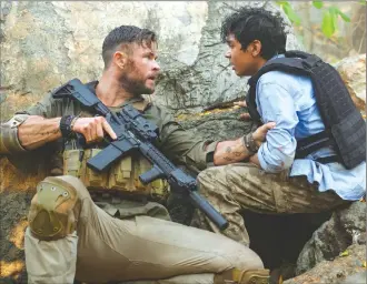  ??  ?? This image released by Netflix shows Chris Hemsworth, left, and Rudhraksh Jaiswal in a scene from the new action film “Extraction.”