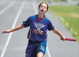  ?? CLIFFORD SKARSTEDT EXAMINER ?? St. Catherine’s Grace Dunn competes in the final leg of Grade 6 girls relay race during the Holy Cross Family of Schools elementary track and field meet on June 16, 2016 at Holy Cross Secondary.