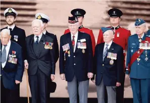  ?? DAN KITWOOD Getty Images ?? Veterans attend a D-Day event on Wednesday in Portsmouth, England, where many of the troops embarked for Normandy on June 5, 1944. Today is the 75th anniversar­y of the D-Day invasion.