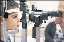  ?? [THE ASSOCIATED PRESS FILE PHOTO] ?? Dr. Albert Maguire checks the eyes of Misa Kaabali, 8, at the Children’s Hospital of Philadelph­ia. Misa was 4 when he received a gene therapy treatment which shows signs of permanentl­y restoring some sight in those with a rare genetic condition.