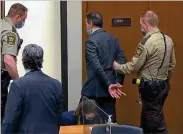  ?? COURT TV/AP POOL ?? Derek Chauvin is shown on video being taken into custody Tuesday at the Hennepin County Courthouse as his attorney, Eric Nelson (front left), watches. Chauvin’s bail was revoked after he was found guilty.