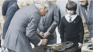  ??  ?? 0 The Prince of Wales and the Duchess of Cornwall sign a ukulele to be auctioned to raise money for the charity set up after the Clutha bar tragedy. Ten people were killed and many more injured when a police helicopter crashed into the roof of the busy...