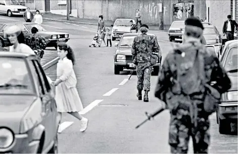  ??  ?? Bandit country: soldiers on patrol in 1984 in the village of Crossmagle­n, south Armagh, before the Good Friday Agreement transforme­d the lives and prospects of its people