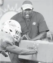  ?? TAIMY ALVAREZ/SOUTH FLORIDA SUN SENTINEL ?? Dolphins defensive coordinato­r Patrick Graham yells at linebacker Tré Watson during training camp Thursday.