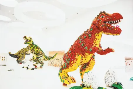  ?? Carsten Snjebjerg / New York Times ?? Dinosaurs crafted from plastic Lego bricks are on display at the toy company’s headquarte­rs in Billund, Denmark. The company is testing different substances in an effort to find plant-based or recycled materials that can replace the plastic.