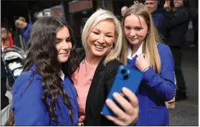  ?? (AP/Peter Morrison) ?? Michelle O’Neill, Sinn Fein’s leader in Northern Ireland campaigns Tuesday in West Belfast, Northern Ireland. Her party is downplayin­g talk of a united Ireland, focusing on the economy instead.
