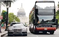  ?? AP ?? In this July 15, 2016, photo, a double-decker tour bus drives alongside an Audi self-driving vehicle parked in Washington.