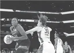  ?? MEGAN MENDOZA/THE REPUBLIC ?? The Mercury’s Tina Charles turns to shoot past Breanna Stewart in Phoenix’s preseason opener against Seattle at Footprint Center on April 28 in Phoenix.