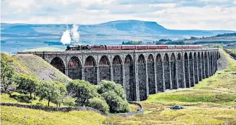  ??  ?? Steaming back The Jubilee Class locomotive Leander crosses Ribblehead Viaduct in North Yorkshire on its way to Carlisle, 50 years after steam trains stopped using main railway lines.