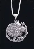  ??  ?? Cast sterling silver wolf pendant by Nancy Wood Taber.