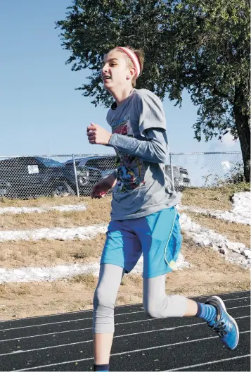  ?? PHOTOS BY MATT DAHLSEID THE NEW MEXICAN ?? St. Michael’s junior Gabe McMahon, who has cerebral palsy, competes in junior varsity races, and his goal is to continue to trim the seconds and minutes off of his best time. McMahon started completing 5-kilometer races in the 35-40 minute range for the first couple of years, until he had his breakthrou­gh late in his sophomore year.