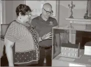  ?? / Doug Walker ?? Chieftains Museum Director Heather Shores (left) shows Cherokee Special Projects Coordinato­r Kevin Stretch a model of the Major Ridge home.