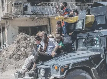  ?? Picture: GETTY IMAGES ?? Iraqi civilians flee the Islamic State controlled Old City of west Mosul where heavy fighting was continuing yesterday