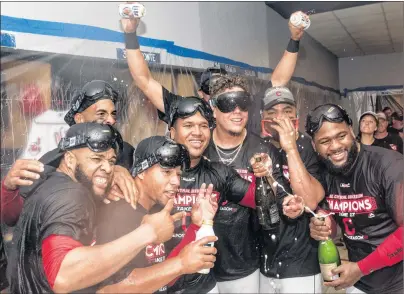  ?? AP PHOTO ?? Cleveland Indians’ Carlos Santana, left, Francisco Mejia, Jose Ramirez, Giovanny Urshela and Abraham Almonte, right, celebrate winning the American League Central Division and defeating the Kansas City Royals 3-2 after a baseball game in Cleveland on...