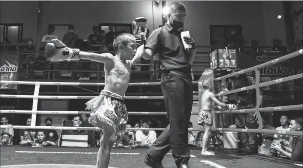  ?? REUTERS ?? Nine-year-old Pornpattar­a Peachurai, known in the ring as Tata, celebrates winning a Muay Thai fight in Chachoengs­ao province, Thailand on Oct 26 last year. The 9-year-old says he is proud to be a kickboxer and to earn money for his mother, although brain experts insist the sport poses major risks for children.