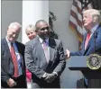  ?? Susan Walsh ?? President Donald Trump talks about Jon Ponder, center, and FBI Special Agent Richard Beasley, left, during a National Day of Prayer event Thursday at the White House.
The Associated Press