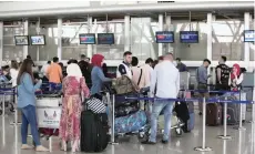  ?? — Reuters ?? Passengers queue at the check-in counters at Erbil Internatio­nal Airport, Iraq, on Wednesday.