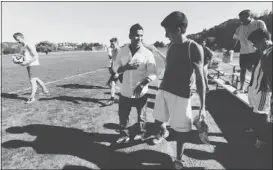  ??  ?? Diango Itzun Reyes, center left, is thanked by Arthur Queiroz after talking to the College of Marin soccer team about the dangers of drinking and driving.