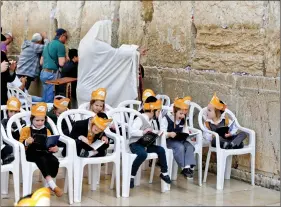  ?? REUTERS ?? Ultra Orthodox Jewish boys are seen during a ceremony at the Western Wall, Judaism’s holiest prayer site in Jerusalem’s Old City, on 29 March 2017.