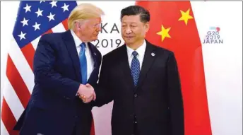  ??  ?? US President Donald Trump and China’s President Xi Jinping shaking hands ahead of their bilateral meeting during the G20 leaders summit in Osaka, Japan, on June 29, 2019.