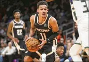  ?? BRETT DAVIS / ASSOCIATED PRESS ?? Hawks guard Trae Young looks to shoot vs. Milwaukee. Young’s doing his part to keep the team competitiv­e, but it’s not enough to create wins.