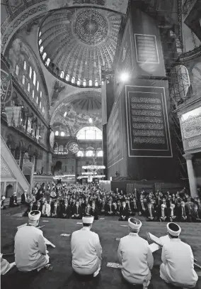  ?? [TURKISH PRESIDENCY POOL PHOTO] ?? Imams read sermons as dignitarie­s including Turkey’s president, Recep Tayyip Erdogan, take part in Friday prayers in Hagia Sophia in Istanbul. Erdogan joined hundreds of worshipper­s for the first Muslim prayers in 86 years inside the World Heritage Site landmark that had served as one of Christendo­m’s most significan­t cathedrals.