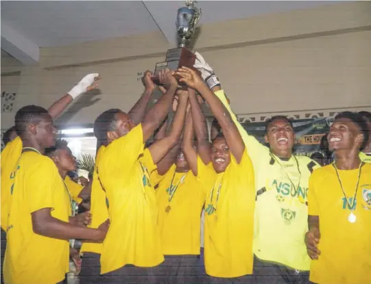  ?? (Photo: Dwayne Richards) ?? Excelsior High celebrate after they retained the Green & Yellow Ali Cole Cup following a 3-2 penalty shoot-out win over Holy Trinity High on Saturday.