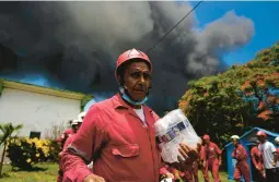  ?? RAMON ESPINOSA/AP ?? Cuban Red Cross members prepare to go to an oil storage facility Saturday in Matanzas, Cuba, Dozens of people have been injured in a fire sparked by lightning.