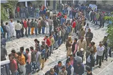  ?? AP PHOTO/ALTAF QADRI ?? People wait to cast their vote at a polling station closest to the Shaheen Bagh protest where Muslim women have been protesting for weeks against a new citizenshi­p law, in New Delhi, India, on Saturday.
