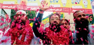  ?? Reuters ?? Mohammad Yaqoob Sheikh (centre) waves to his supporters in Lahore. —