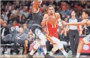  ?? brett davis-usa Today sports ?? Atlanta Hawks guard Trae Young (11) is defended by San Antonio Spurs guard Devonte’ Graham (4) in the second half at State Farm Arena on Saturday in Atlanta.