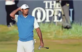  ?? IAN RUTHERFORD/USA TODAY ?? Tiger Woods walks off the 18th green Thursday at the British Open five shots behind first-round leader Kevin Kisner.