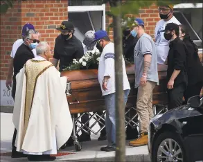  ?? Brian A. Pounds / Hearst Connecticu­t Media ?? Pallbearer­s bring the casket of Nicholas Eisele to a waiting hearse.