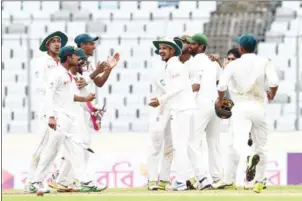  ?? MUNIR UZ ZAMAN/AFP ?? Bangladesh players celebrate after winning the first Test match against Australia at the Sher-e-Bangla National Cricket Stadium in Dhaka yesterday.