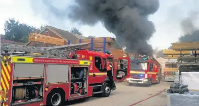  ?? Charlotte Dobson ?? ●●Firefighte­rs tackle the blaze at Stockport Timber