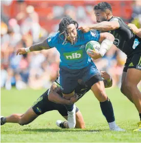  ?? Photo / Photosport ?? Hurricanes defenders double up on the tackle of Blues midfield back Ma’a Nonu in Mangataino­ka.